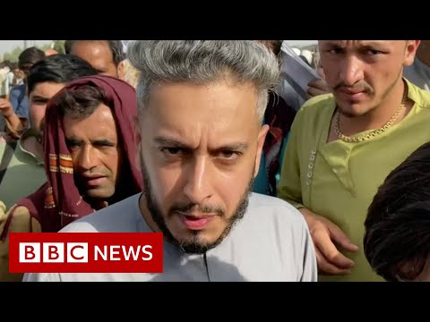 BBC surrounded by people showing papers at Kabul airport – BBC News