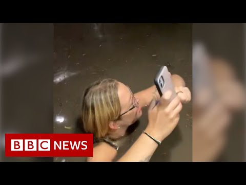 Friends trapped in flooding elevator during US storm – BBC News