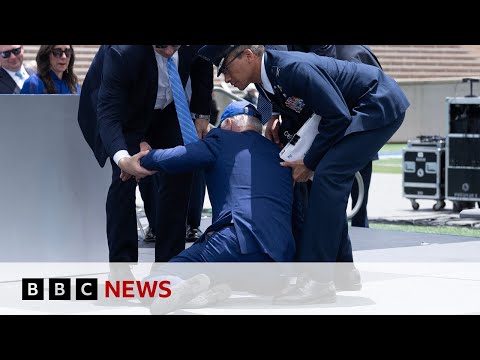 US President Biden trips and falls over at graduation event – BBC News