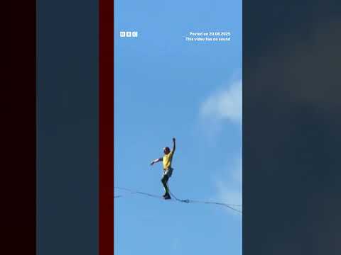 Competitors walk slackline 400m above a Chinese gorge. #BBCNews