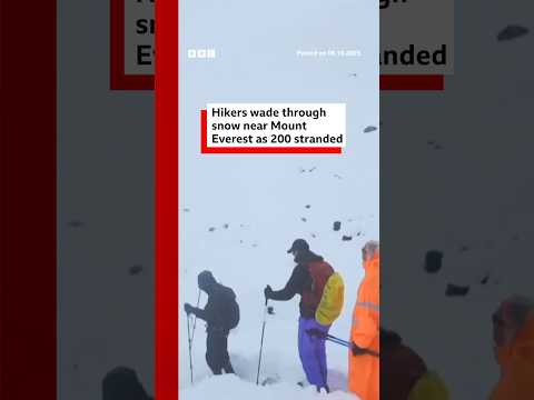 Hikers wade through snow near Mount Everest as 200 stranded. #BBCNews